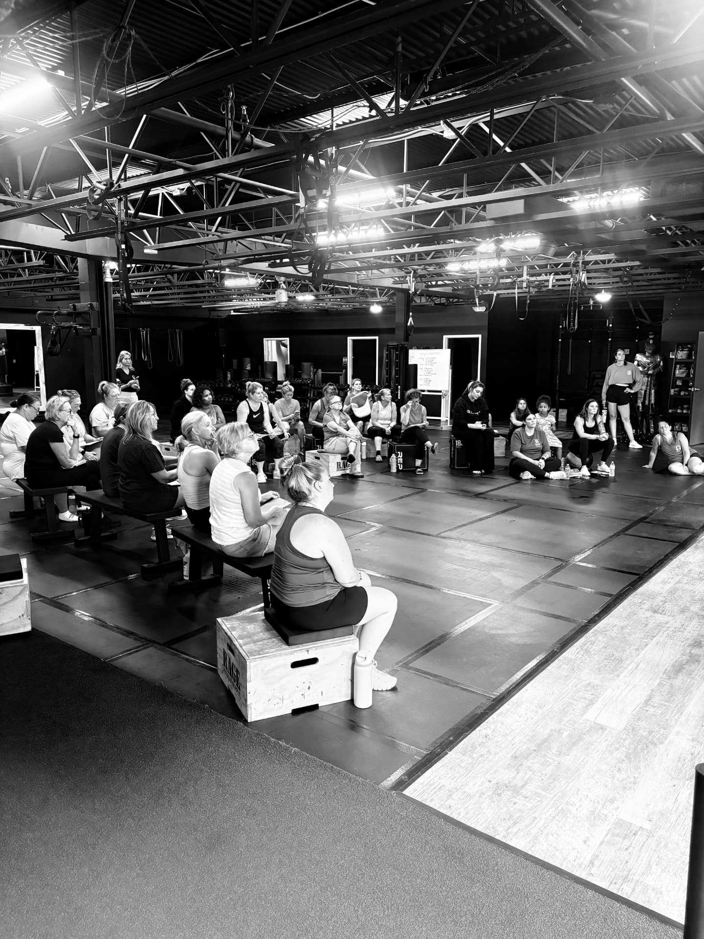 Fitness Artist members gathered in a circle during an educational community session